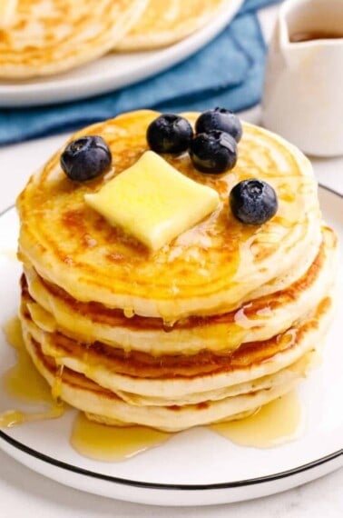 A stack of classic Bisquick pancakes topped with butter and blueberries.