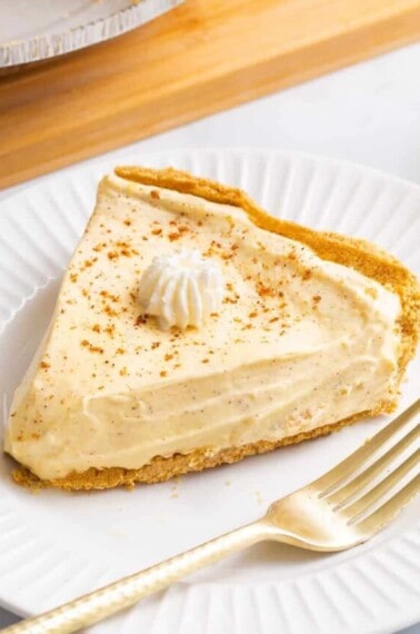 A slice of no bake eggnog pie on a plate.