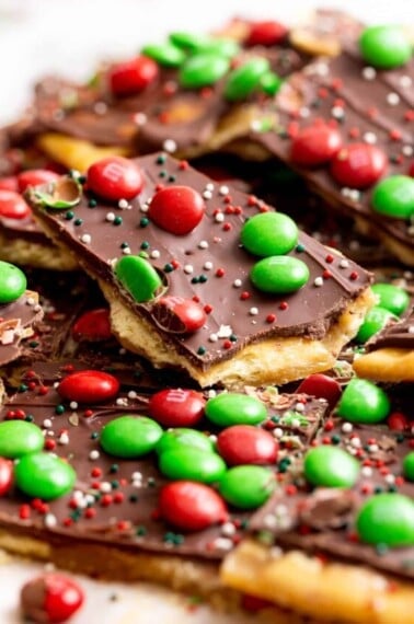 Pieces of Christmas crack topped with M&Ms and sprinkles.