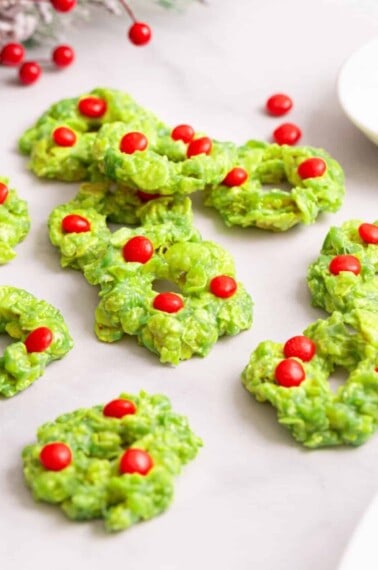 Christmas wreath cookies decorated with red candies.