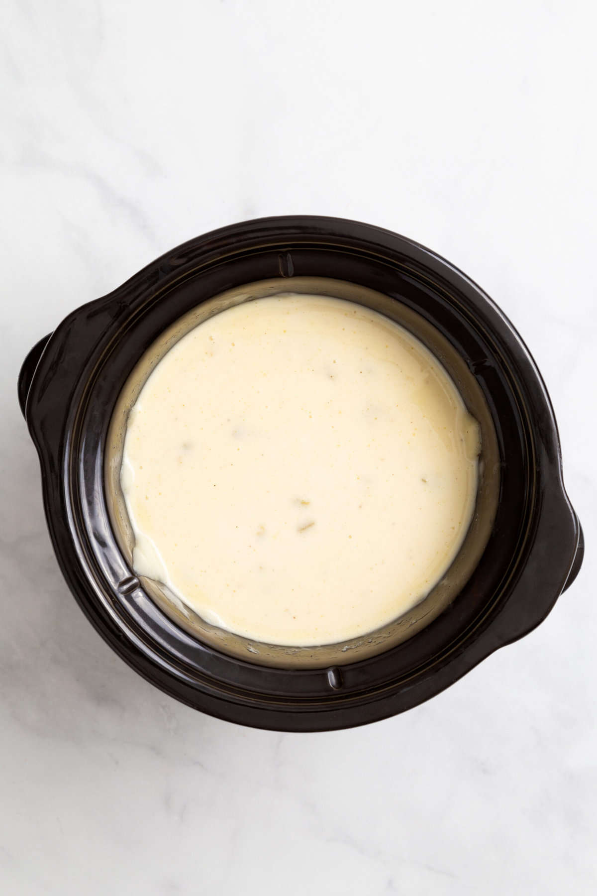 top down image of Velvetta Queso Blanco in a slow cooker. 