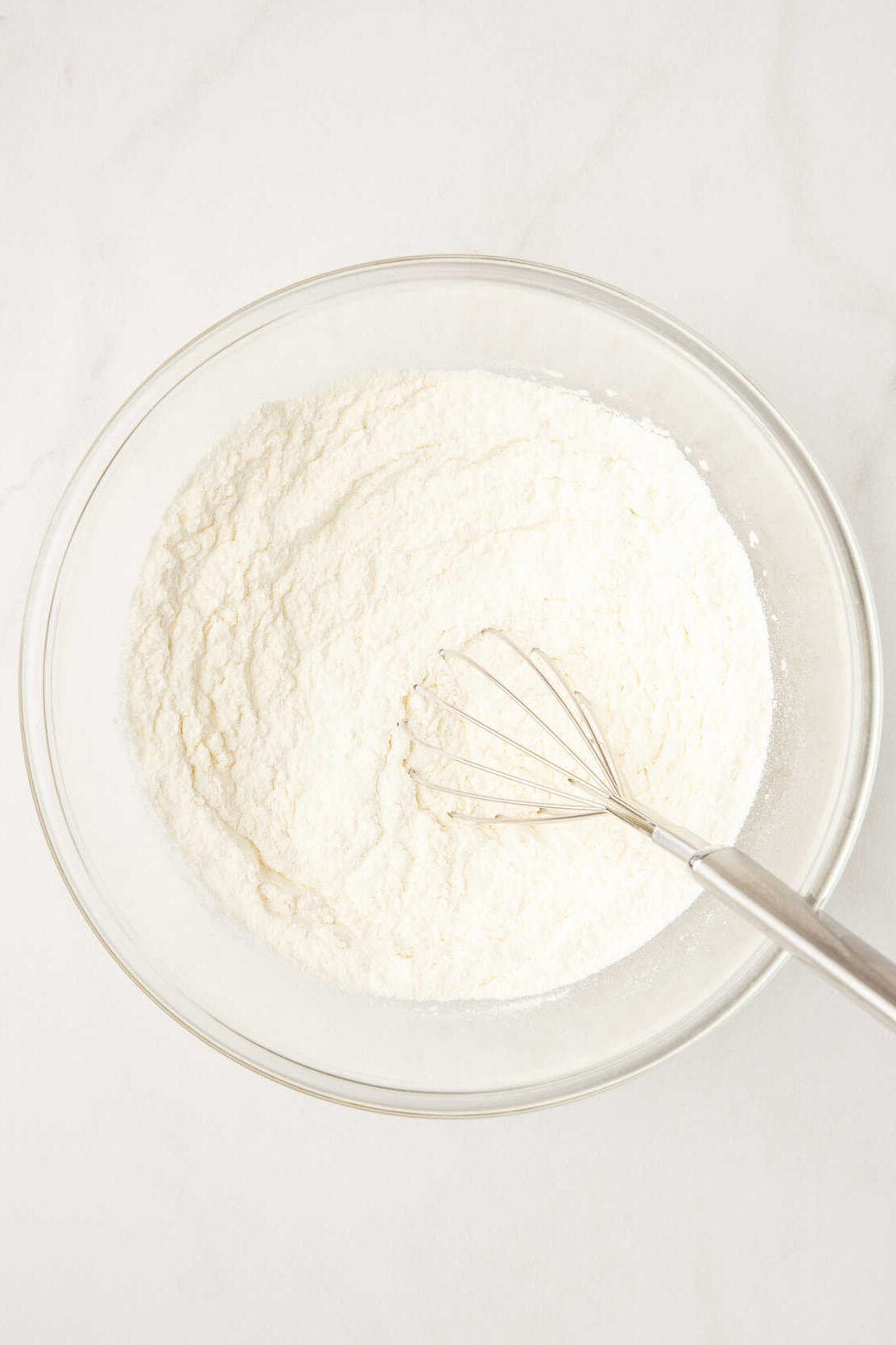 flour mix with a whisk in a large glass bowl. 