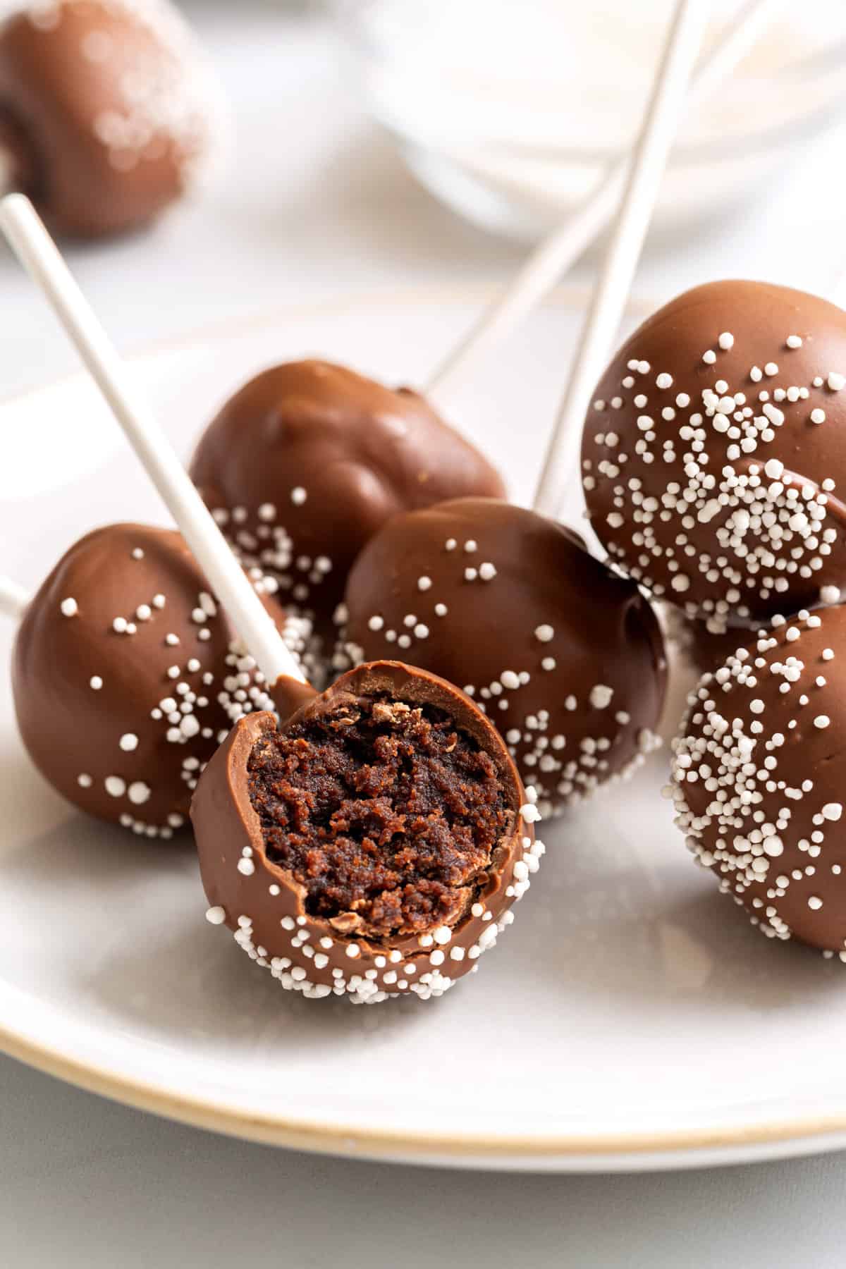 plate of 6 starbucks chocolate cake pops served on a white round plate. 