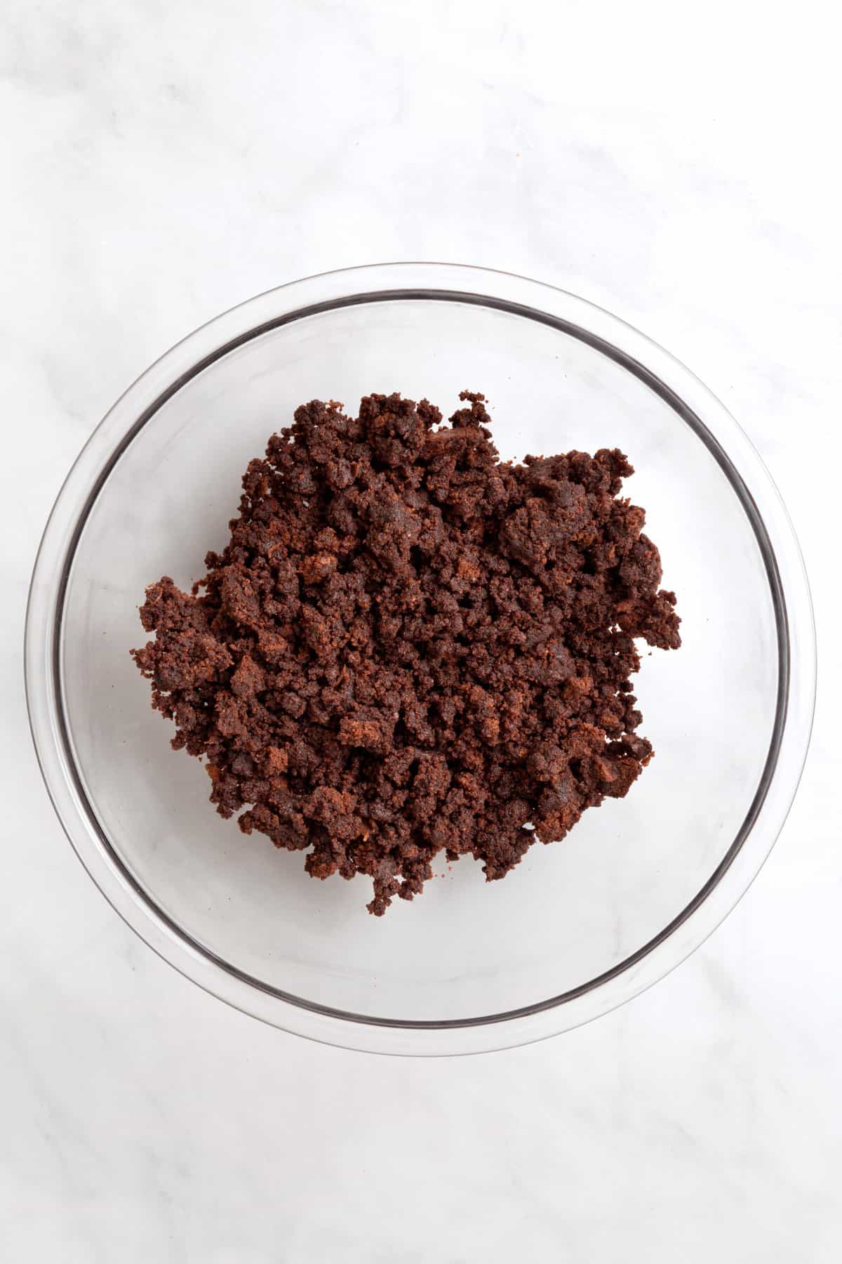chocolate cake crumbled in a large glass bowl. 