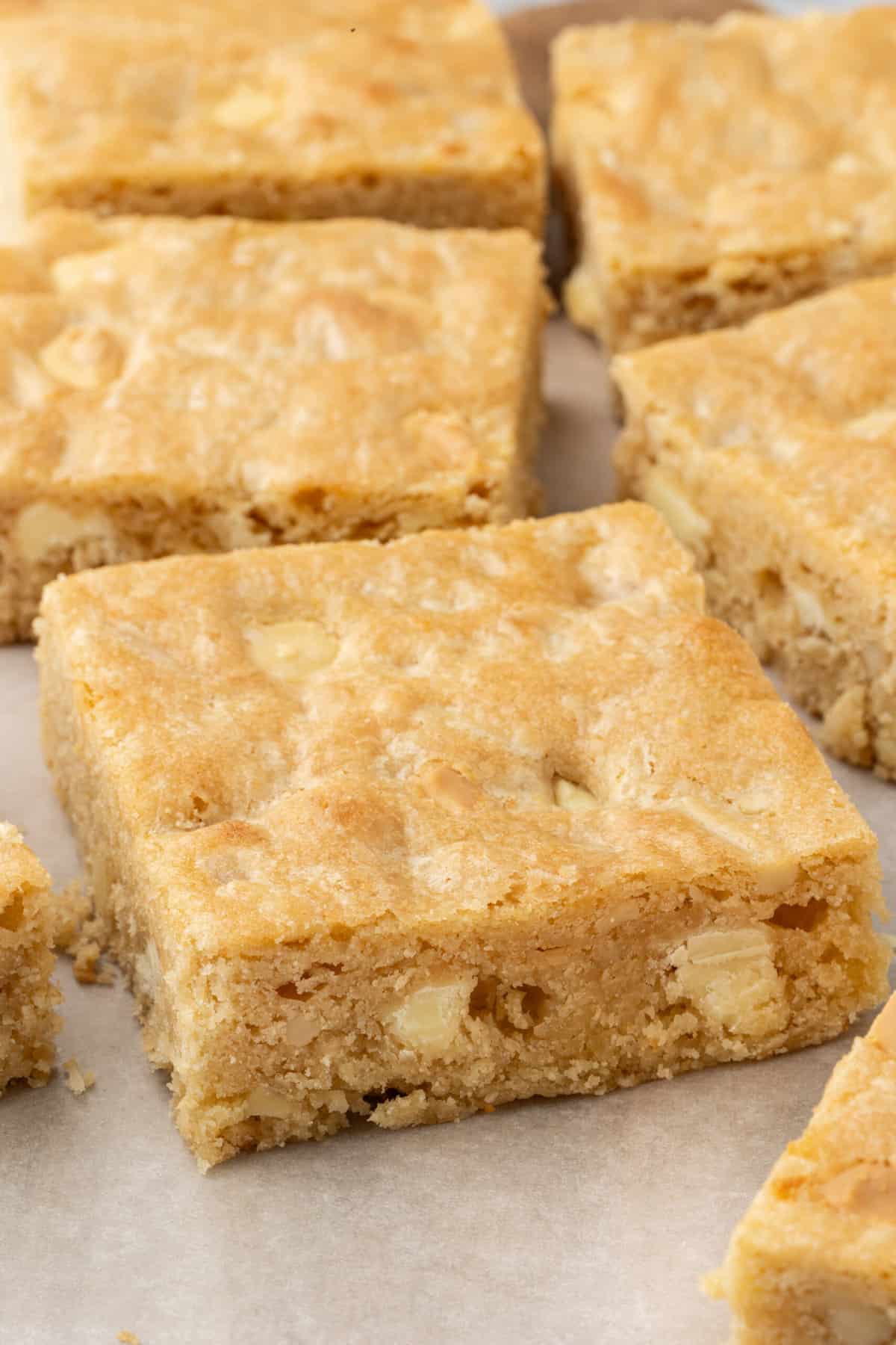 close up image of blonde brownies cut into squares. 