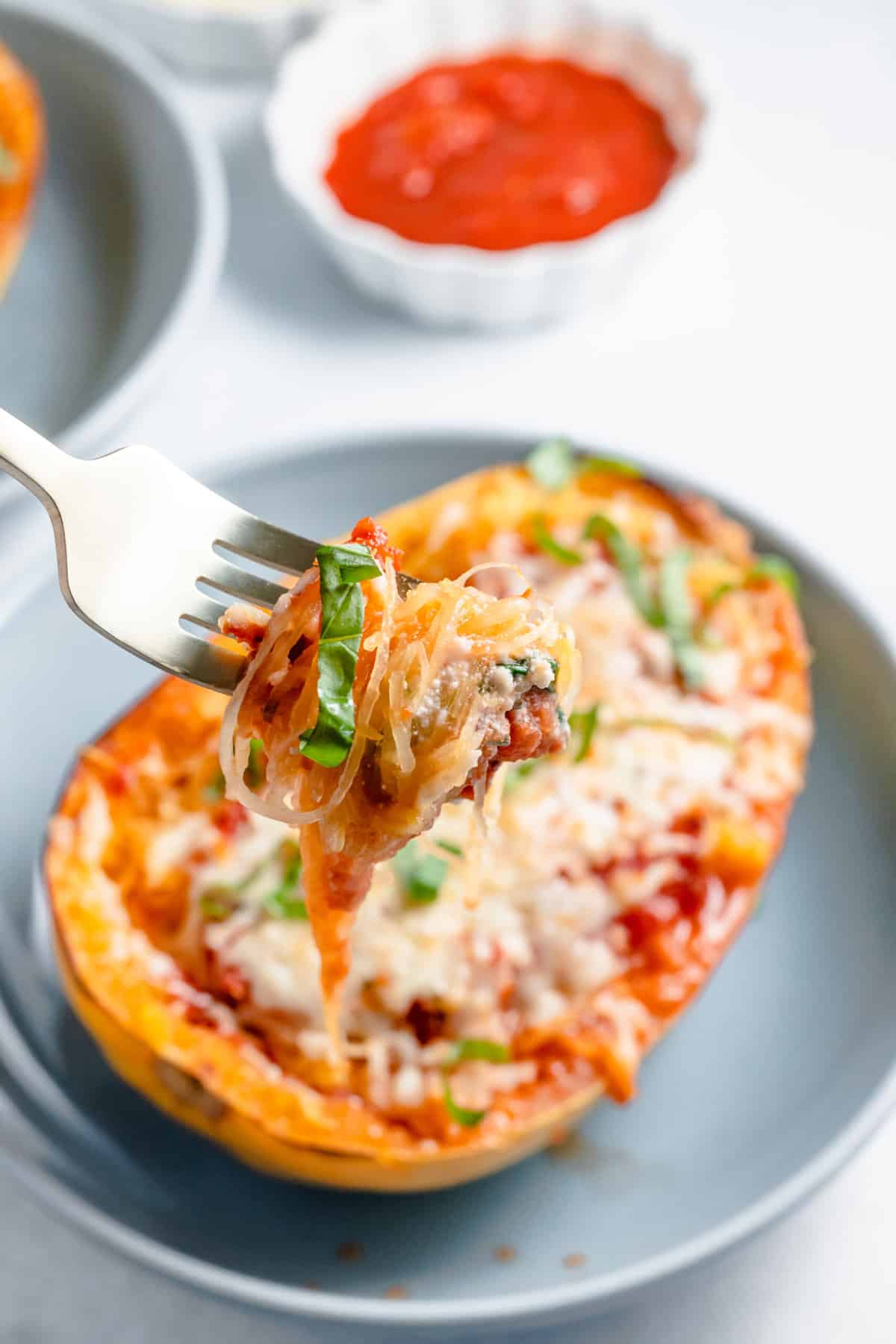 close up image of a forkful of stuffed lasagna spaghetti squash.
