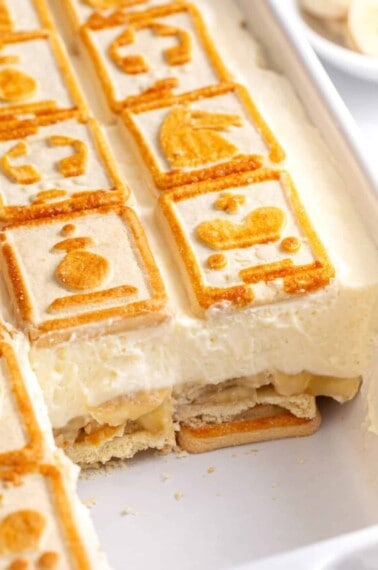 Chessman banana pudding in a baking dish with a serving missing.