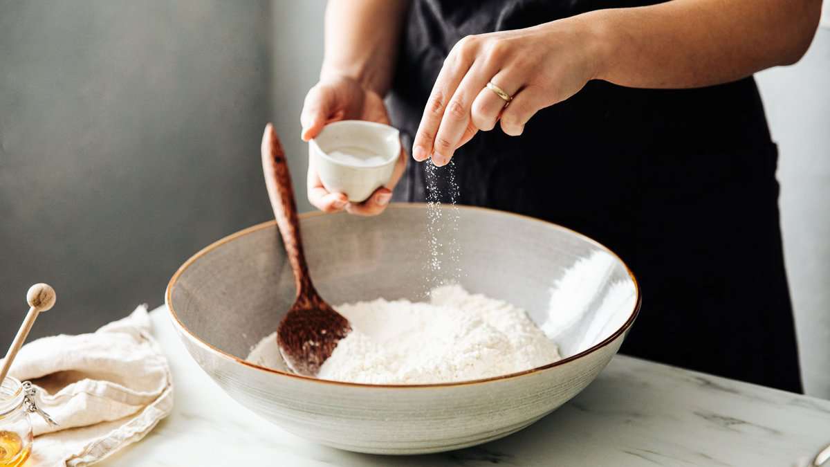 Salt being sprinkled in flour. 