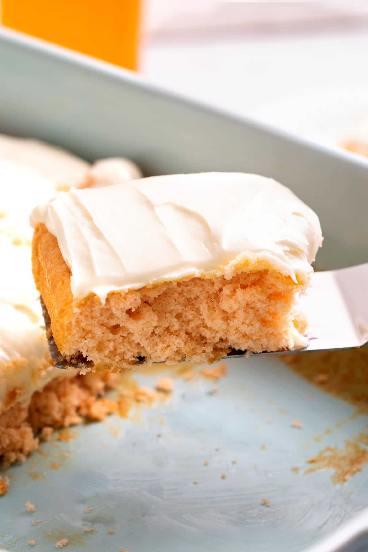 close up image of a square slice of soda cake sitting on a metal spatula. 