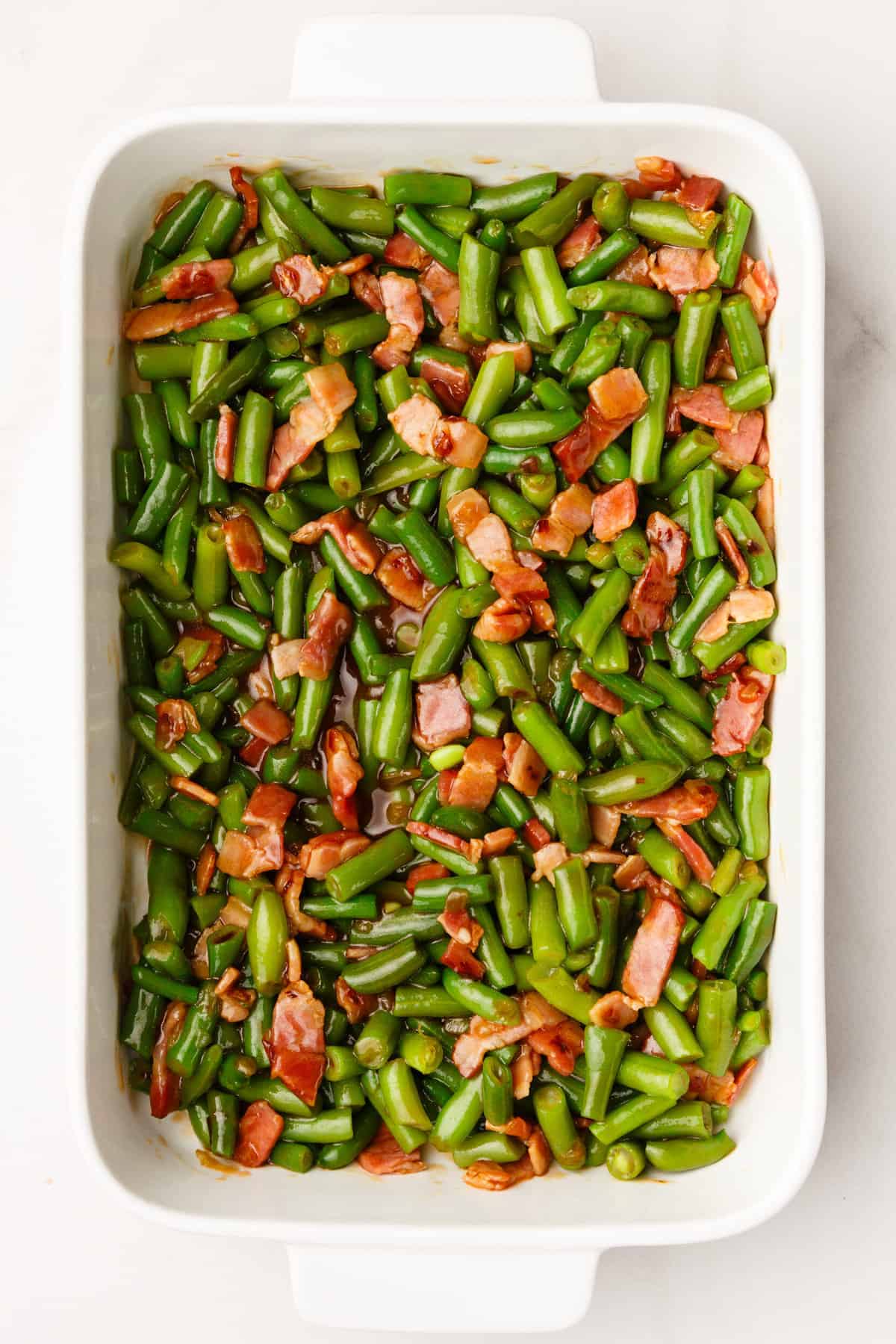 top down image of crack green beans sitting in a 9x13 inch casserole dish. 