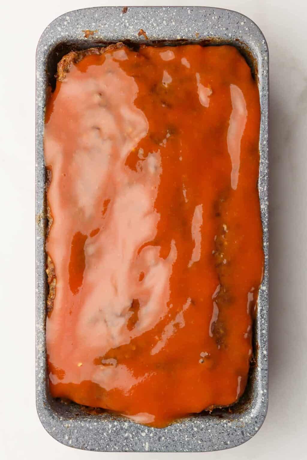 cracker barrel meatloaf baked in a 9x4 inch loaf pan topped with a ketchup mixture sauce.