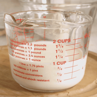 A liquid measuring cup of homemade buttermilk.