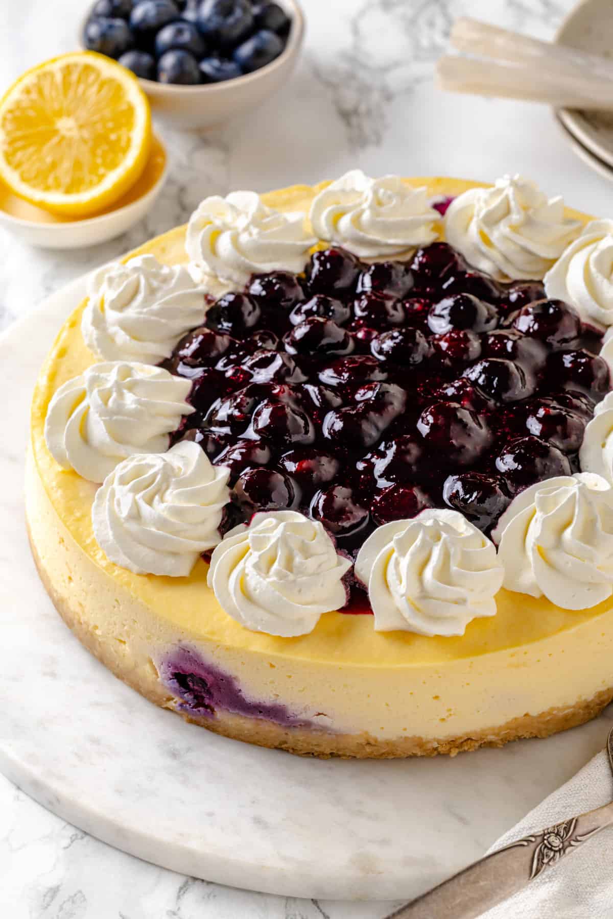 close up image of baked homemade lemon blueberry cheesecake.