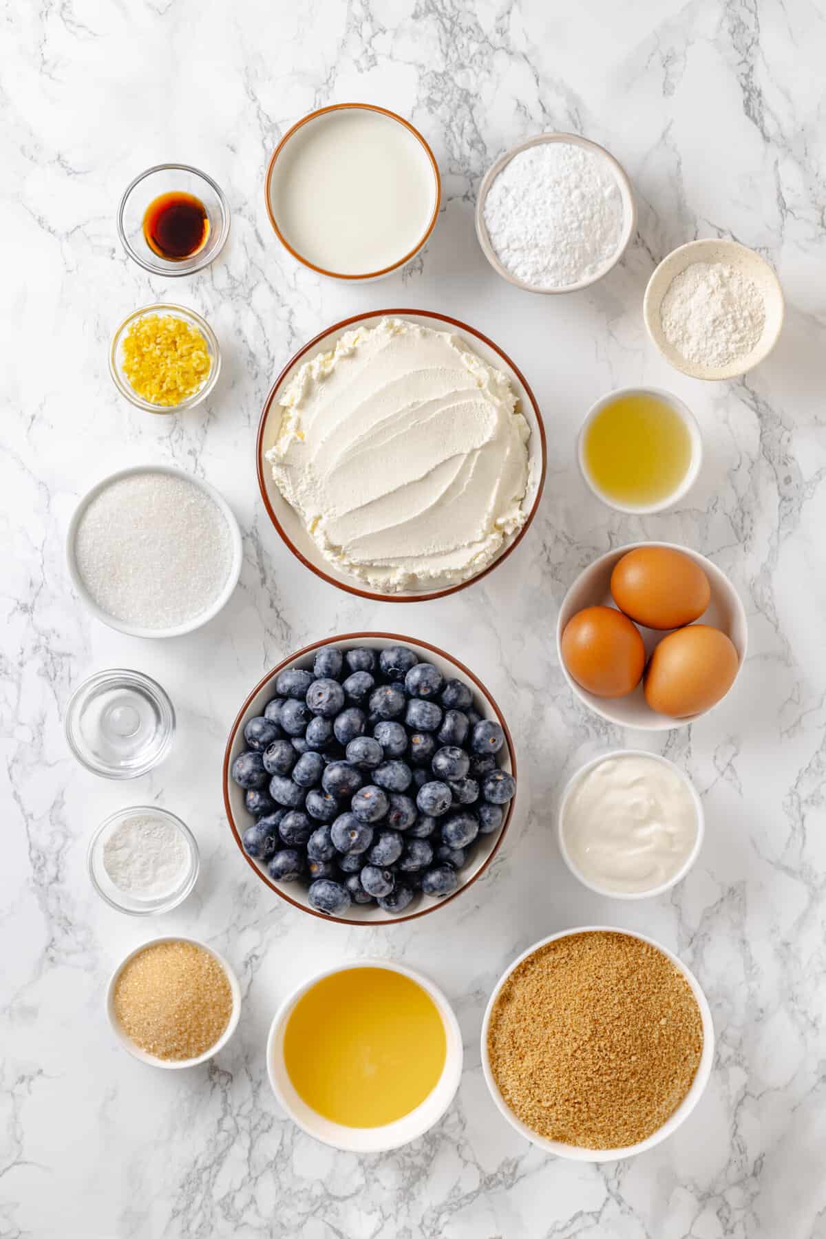 ingredients to make lemon blueberry cheesecake.