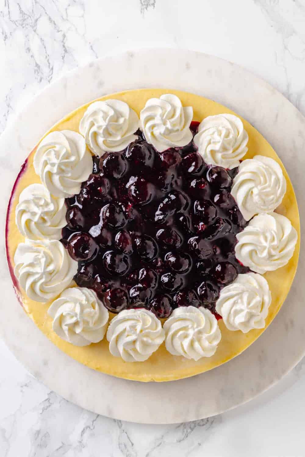 top down image of finished lemon blueberry cheesecake.