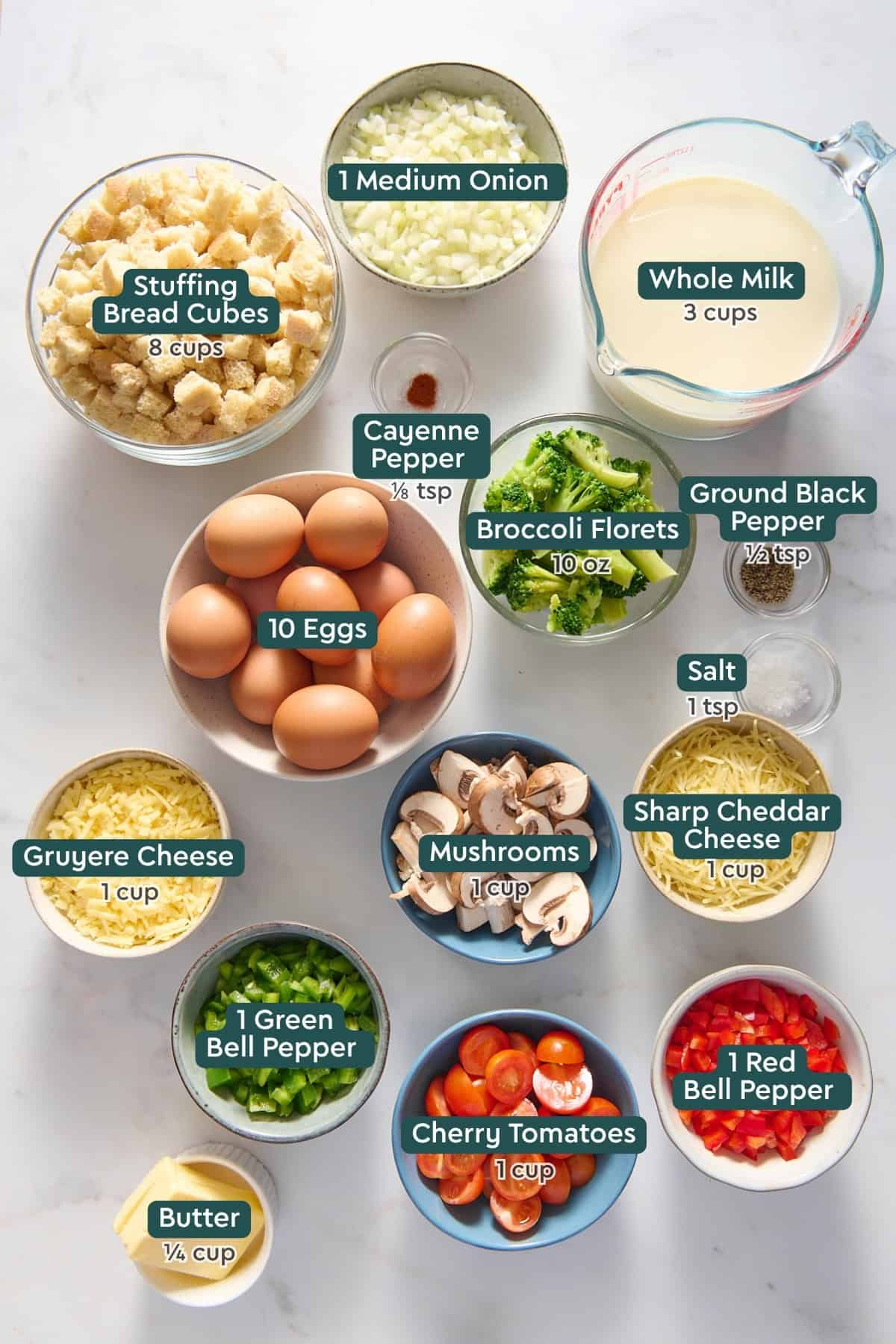 Ingredients for vegetarian breakfast casserole, including onion, milk bread, seasonings, broccoli, eggs, mushroom, cheese, pepper, tomatoes, butter.