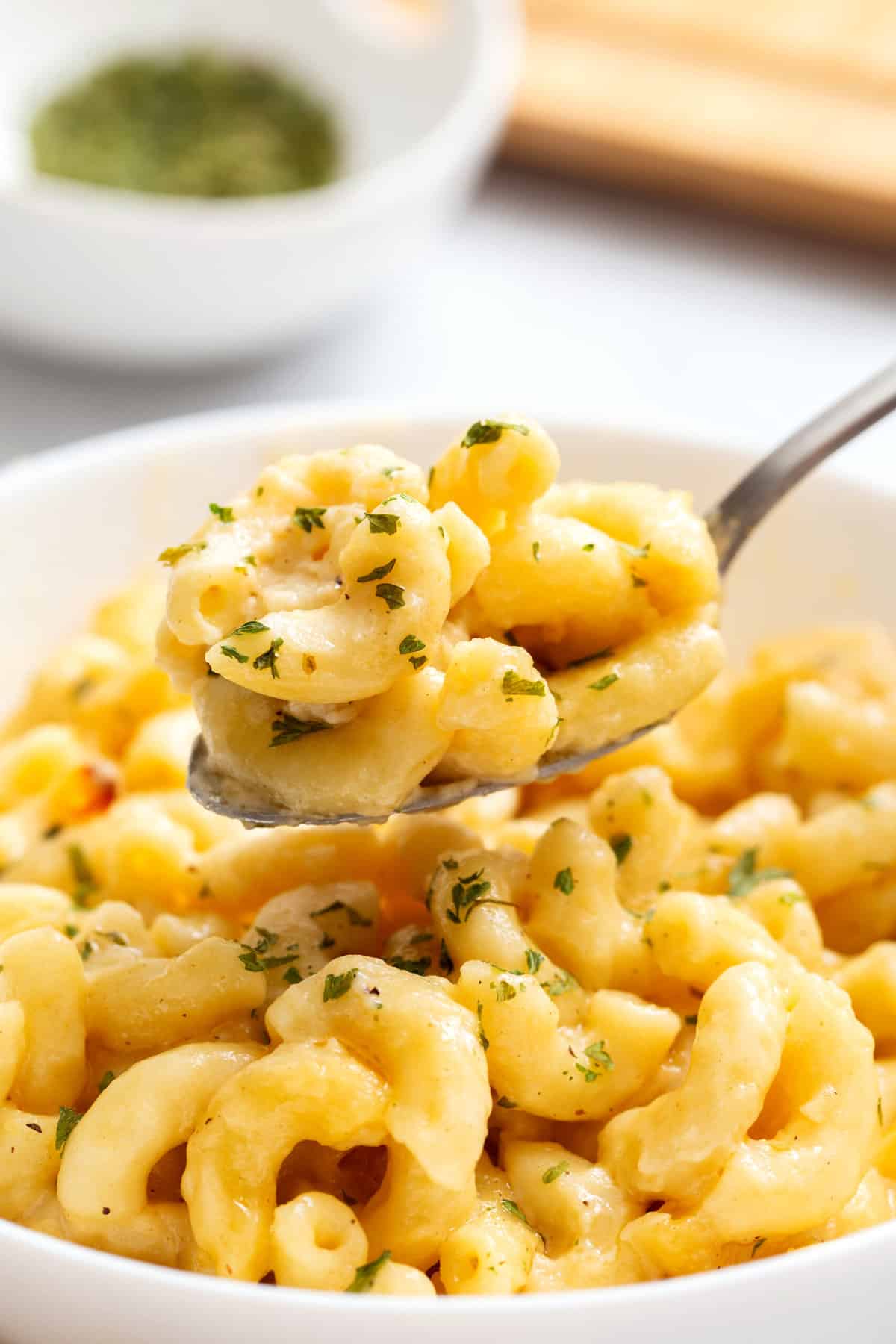 close up image of a spoonful of cracker barrel mac and cheese. 