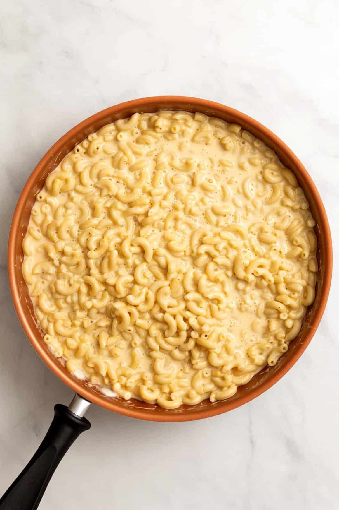 top down image of a large skillet of cracker barrel mac and cheese.