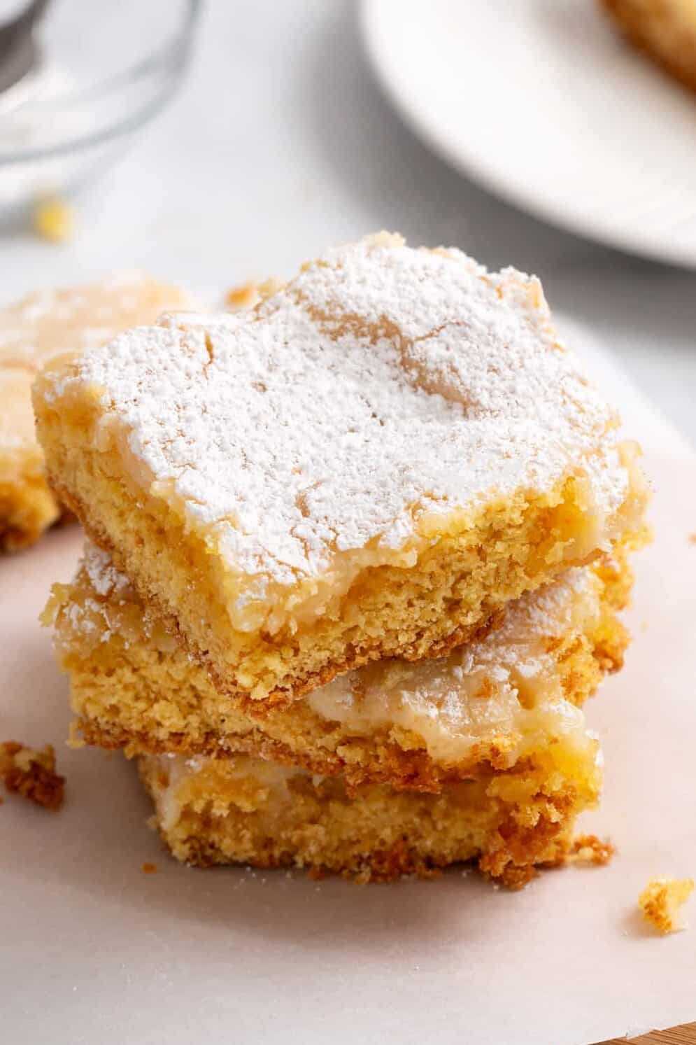 close up image of a stack of three cream cheese bars. 