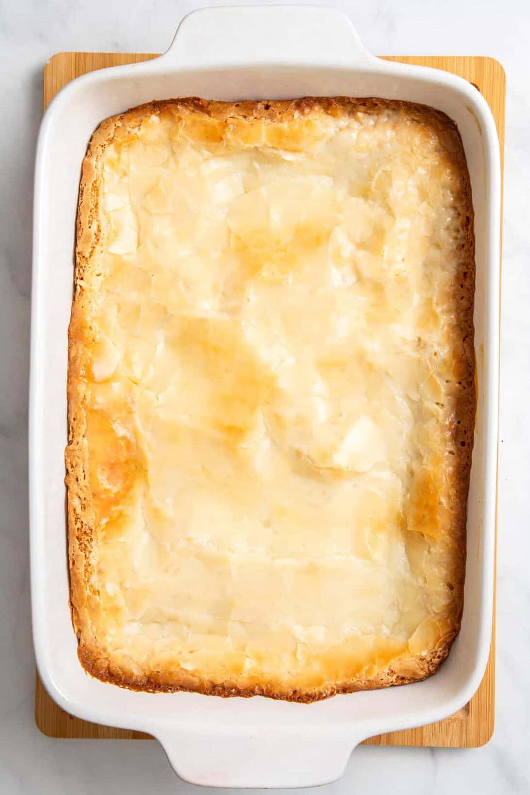top down image of a 9x13 casserole dish of cream cheese bars. 