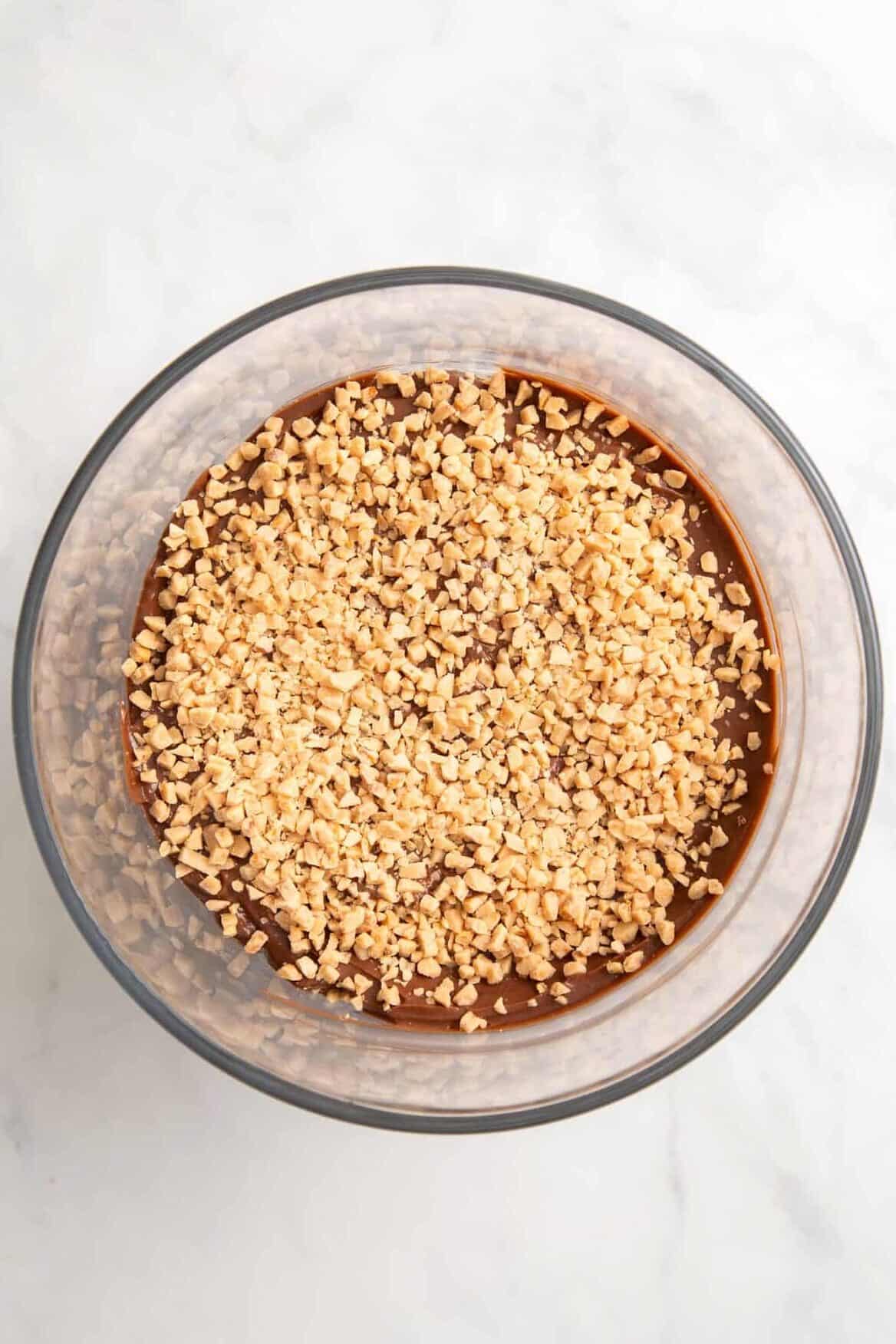 top down image of a large trifle glass  with chocolate pudding layer and crushed toffee bits. 