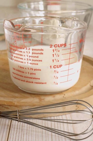 glass measuring cup with buttermilk.