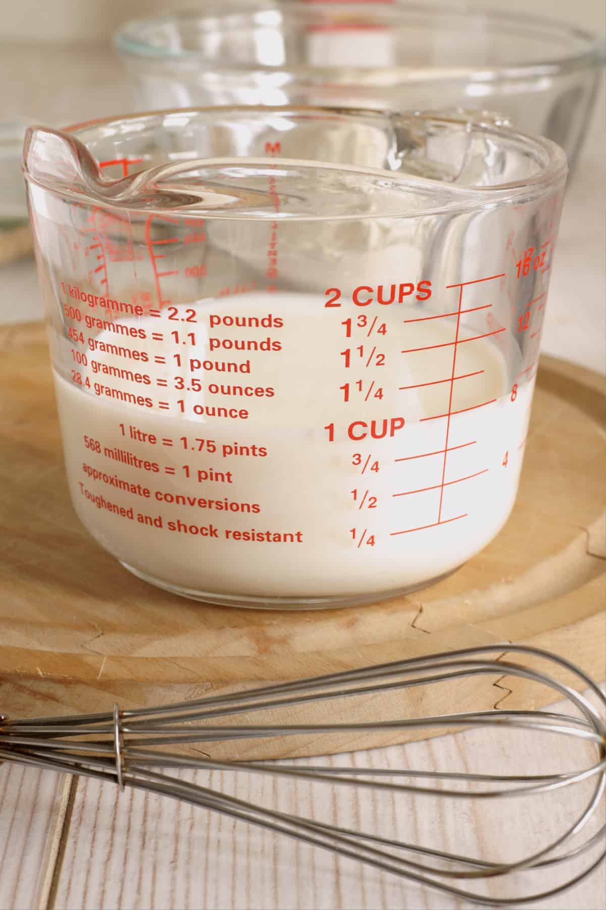 glass measuring cup with buttermilk. 
