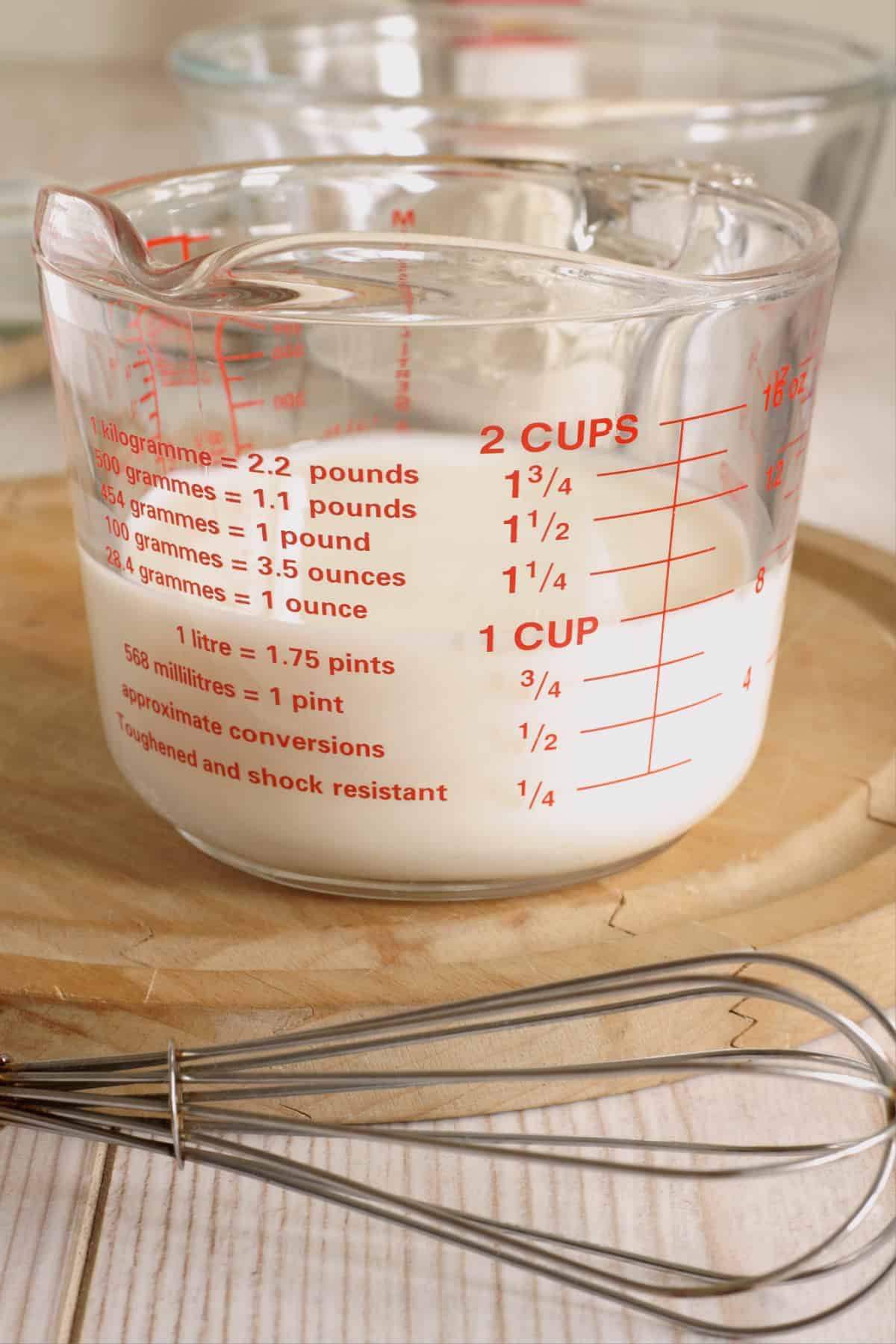 glass measuring cup with buttermilk.