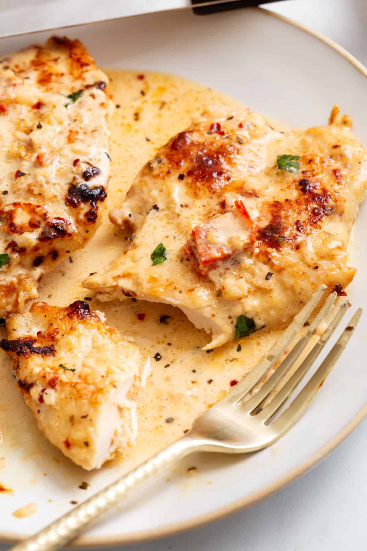 close up image of marry me chicken served on a plate.