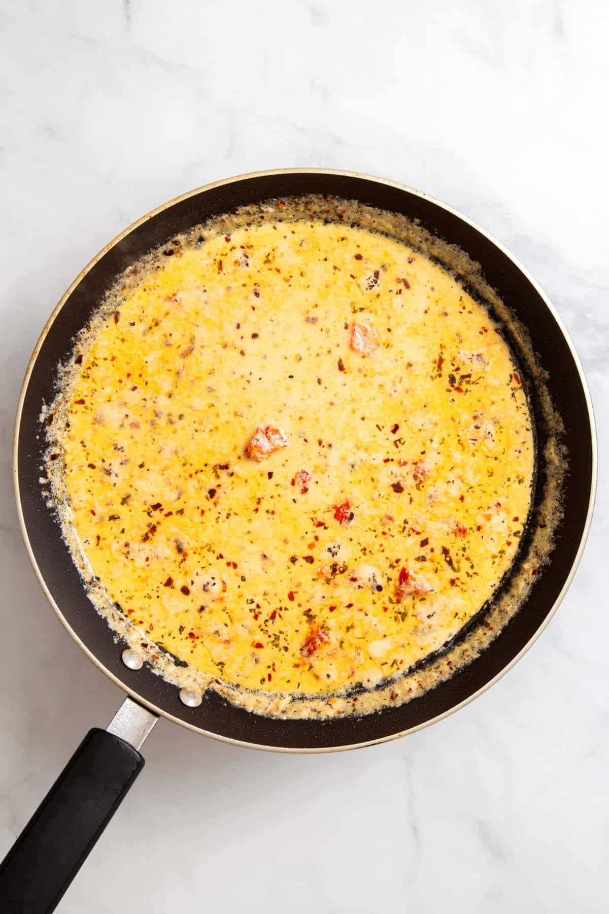 top down image of a skillet with marry me chicken sauce.