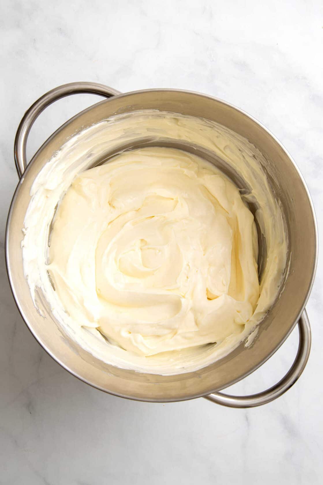 top down image of Philadelphia No Bake Cheesecake filling in a stainless steel mixing bowl. 