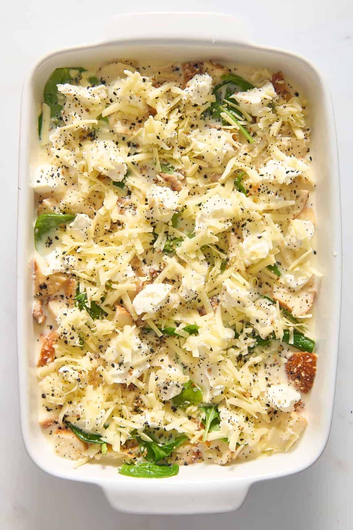 top down image of everything bagel breakfast casserole served in a 9x13 inch casserole dish.