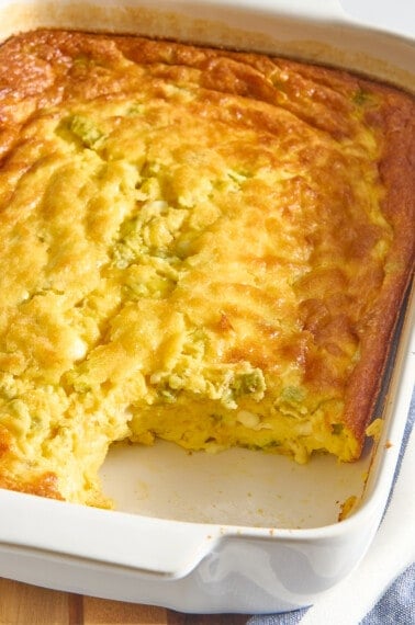 Green chili egg casserole with a serving missing.