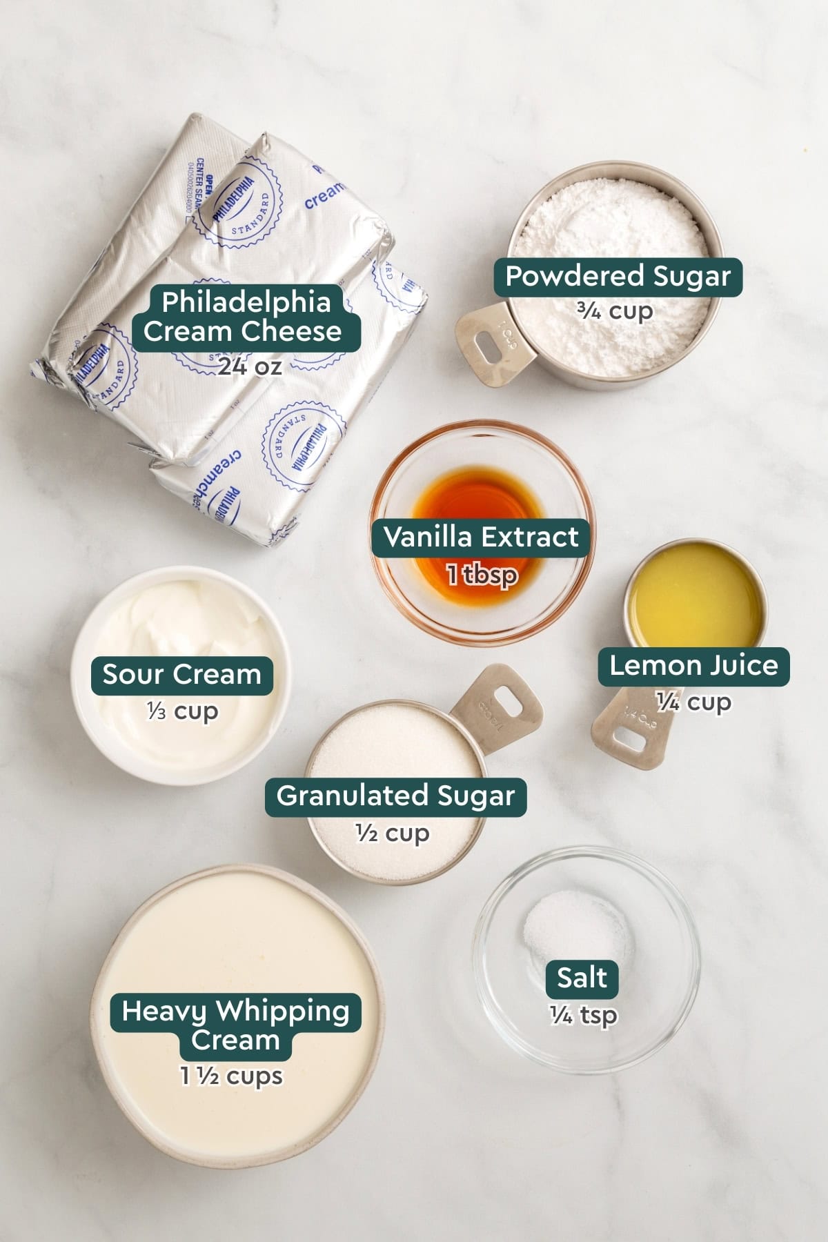 Ingredients for Philadelphia no bake cheesecake, including cream cheese, powdered sugar, sour cream, vanilla, lemon juice, sugar, whipping cream, salt.