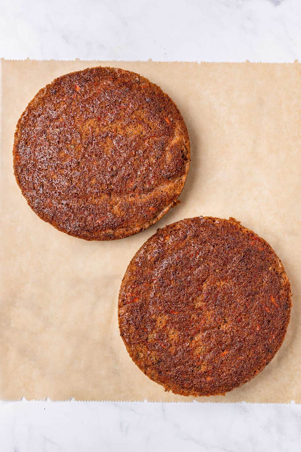 top down image of two 9-inch baked carrot cakes.