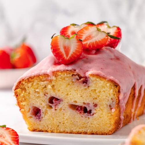 Strawberry pound cake with strawberry glaze missing a slice.
