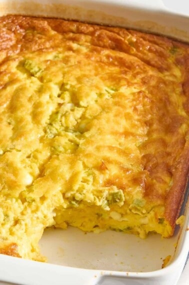 Green chili egg casserole with a serving missing.