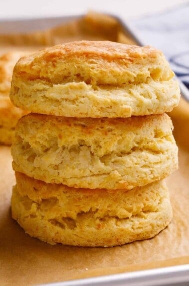 Three homemade Popeyes biscuits stacked on top of each other.