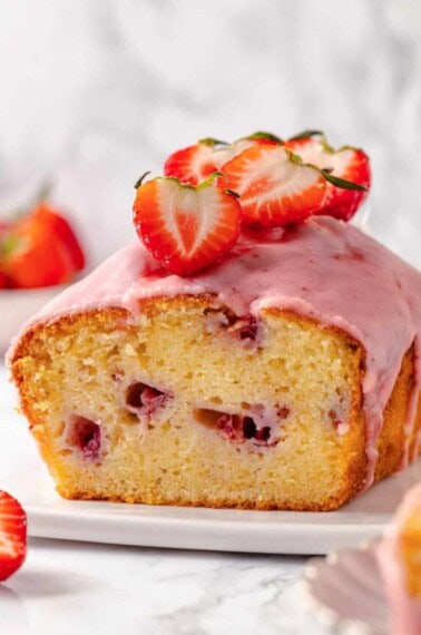 Strawberry pound cake with strawberry glaze missing a slice.