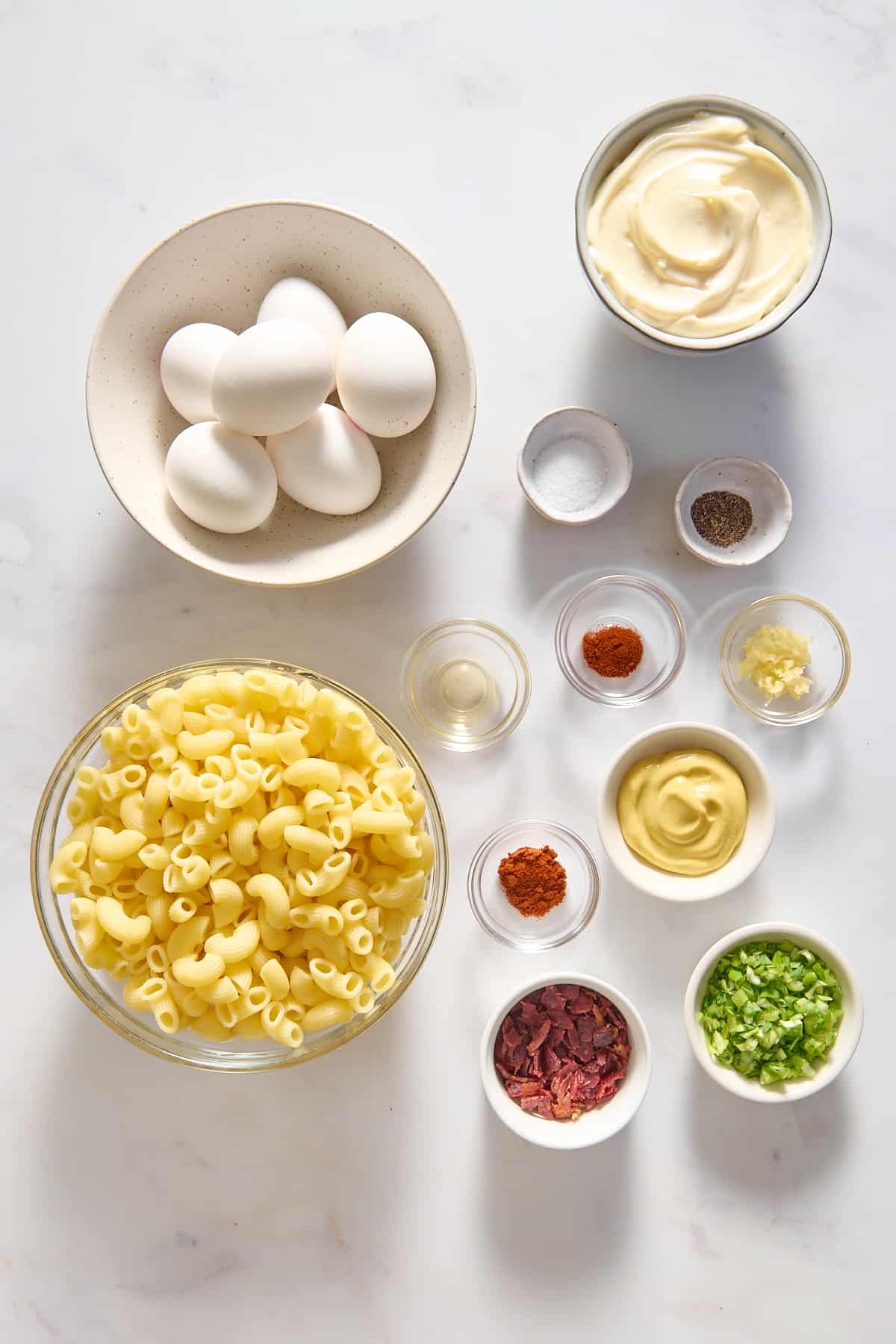 Ingredients to make deviled egg, pasta salad.