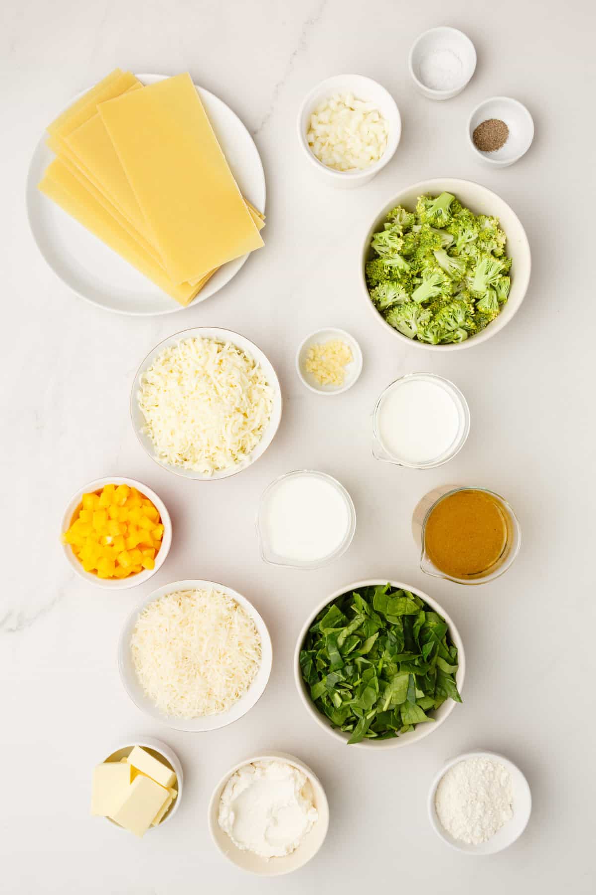 Ingredients to make easy, vegetable lasagna with white sauce.
