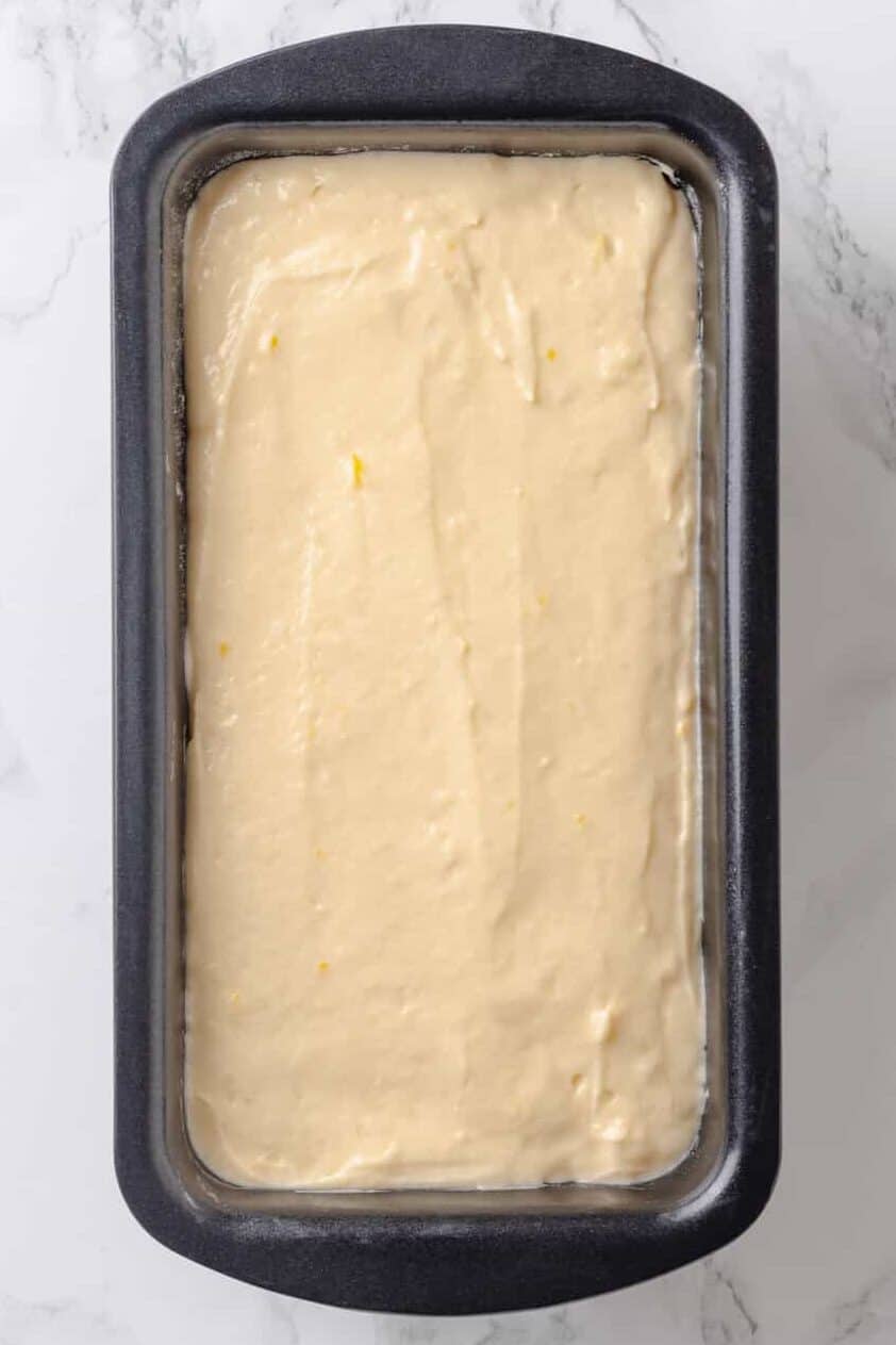 Top image of a 9 x 4 loaf baking pan with lemon pound cake batter.