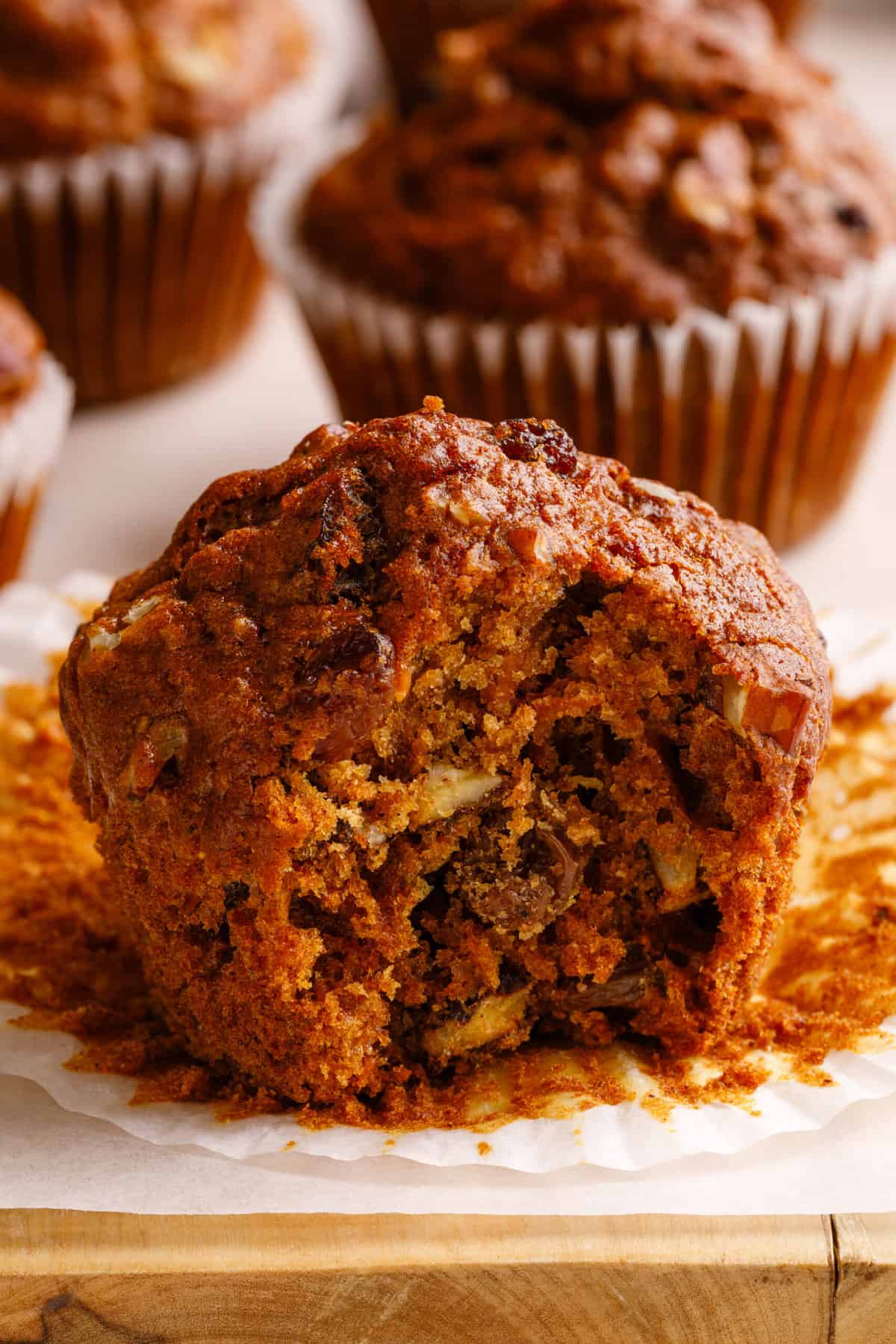 close up image of a morning glory muffin with a bite taken out of it. 