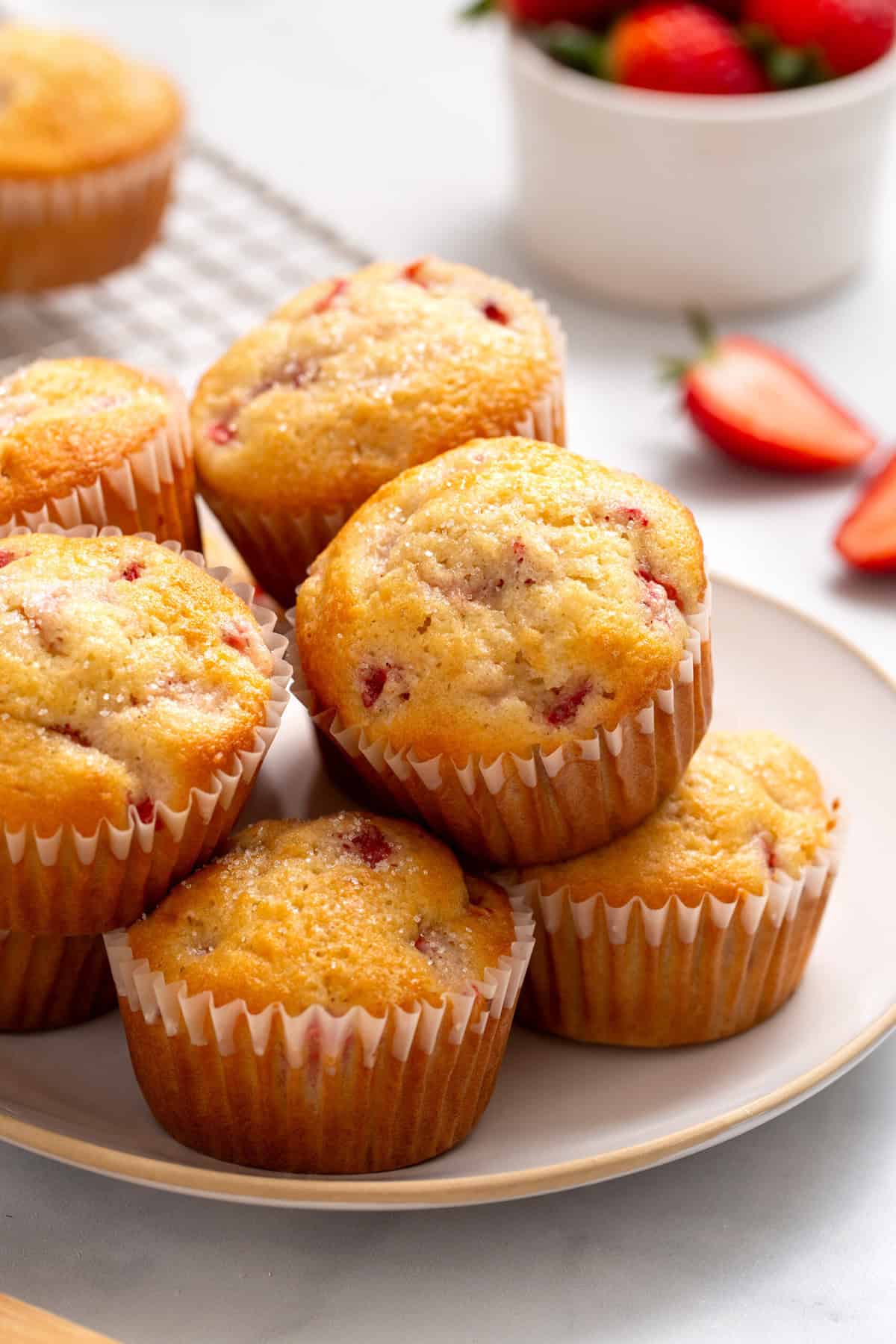 Close-up image of a plate of a pile of strawberry muffins.
