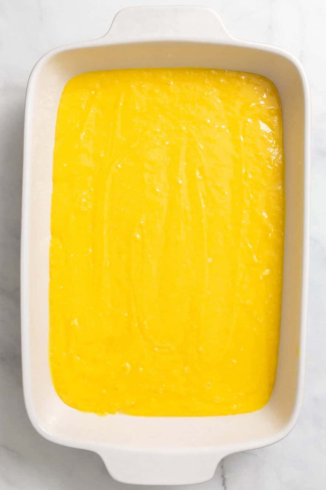 Image of a 9 x 13" casserole baking dish with lemon cake batter.