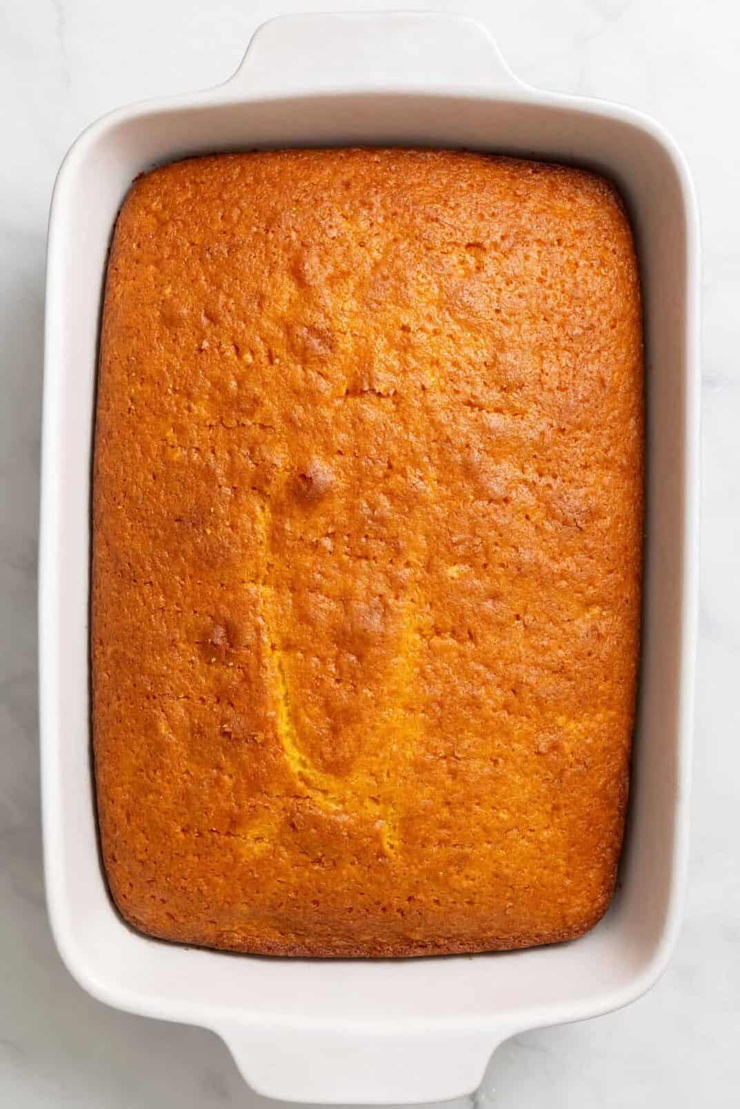 Top down image of a 9 x 13 casserole dish with baked lemon cake.