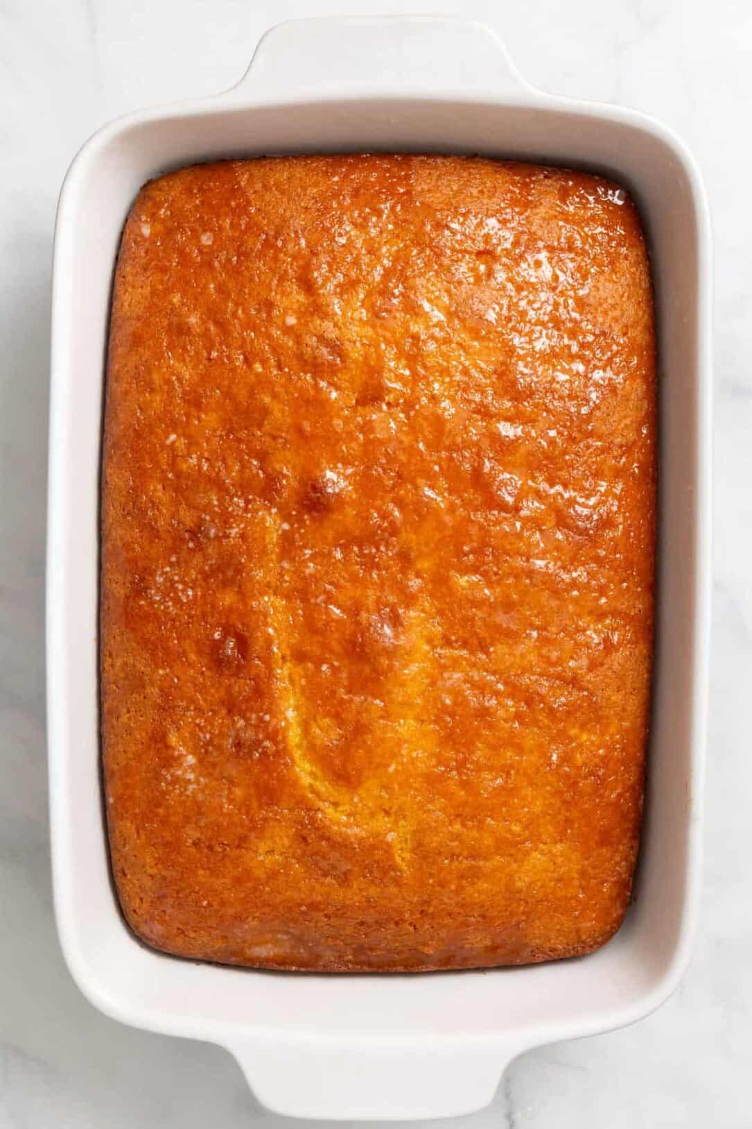 Top down image of a 9 x 13 casserole dish with baked lemon cake.