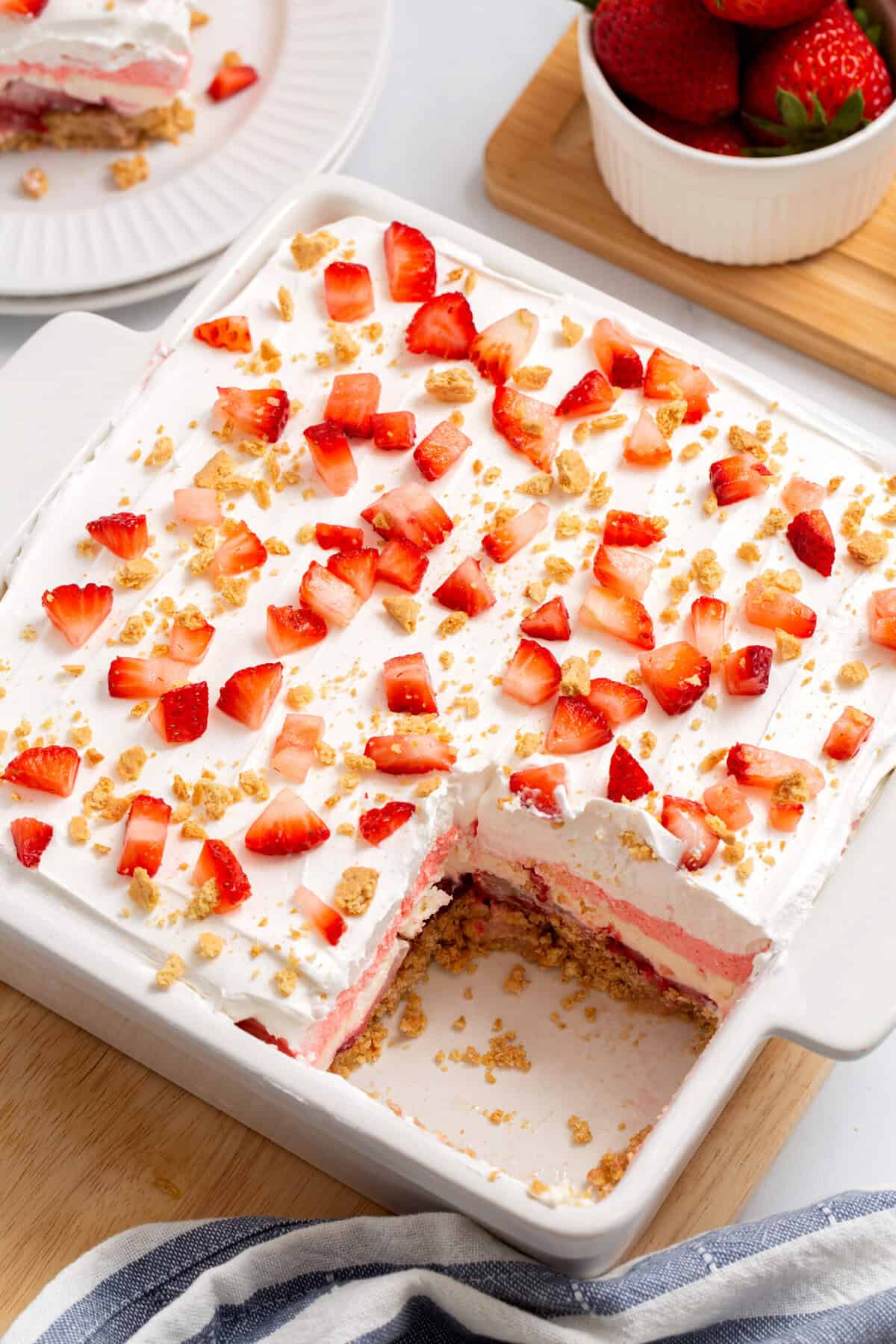 Top down image of an 8 x 8 baking dish with strawberry delight dessert.