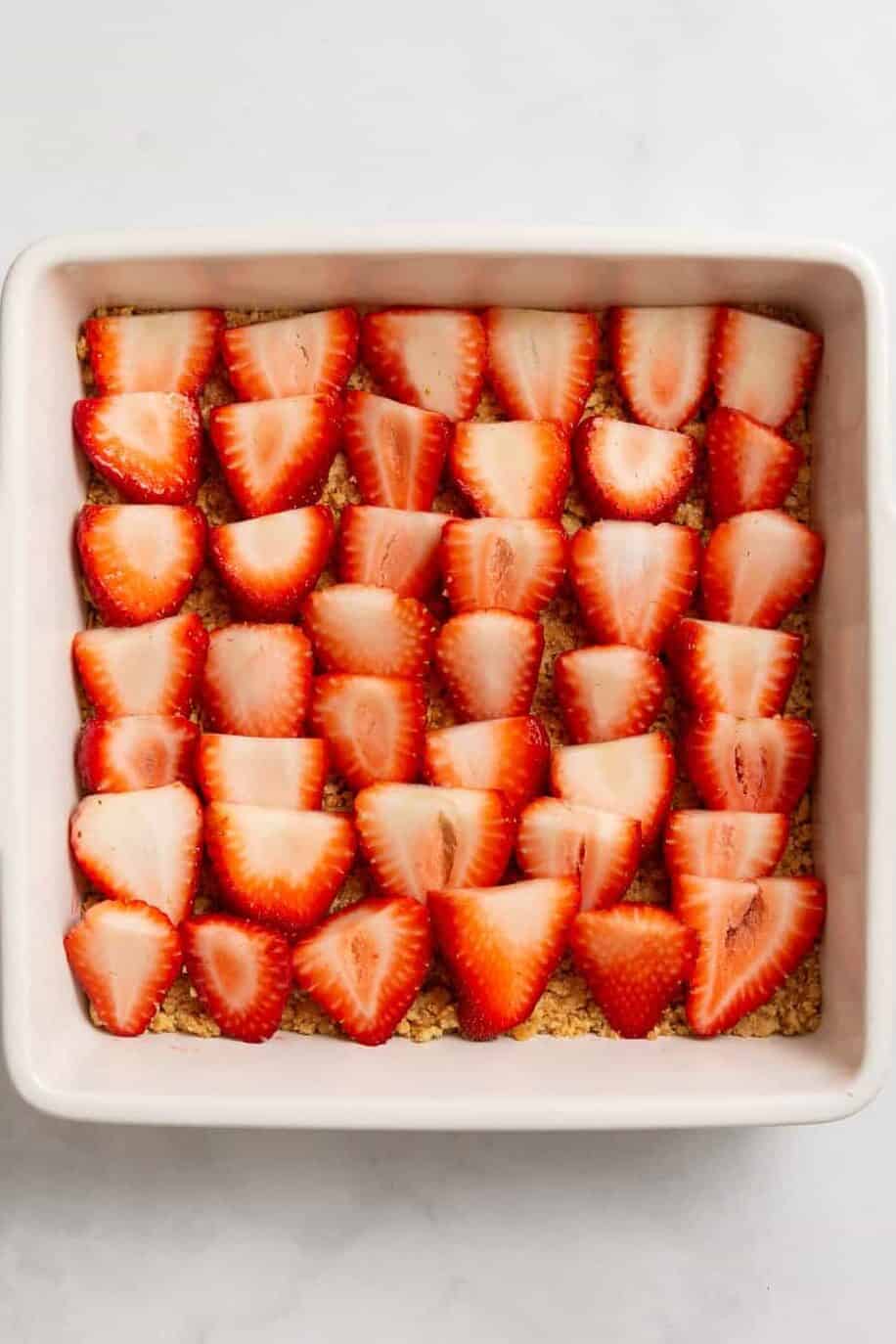 dish of fresh strawberries sliced sliced strawberries in a baking dish.