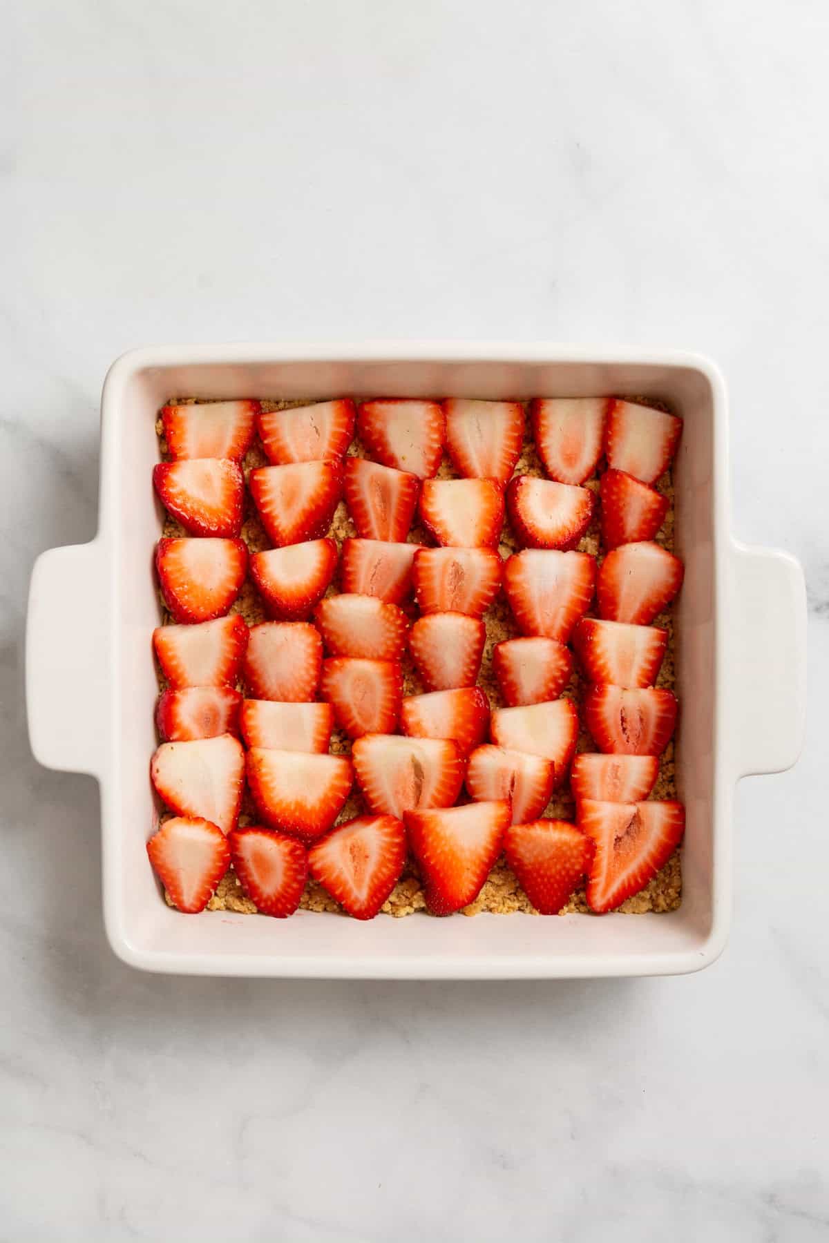 Strawberries layered over graham cracker crust.